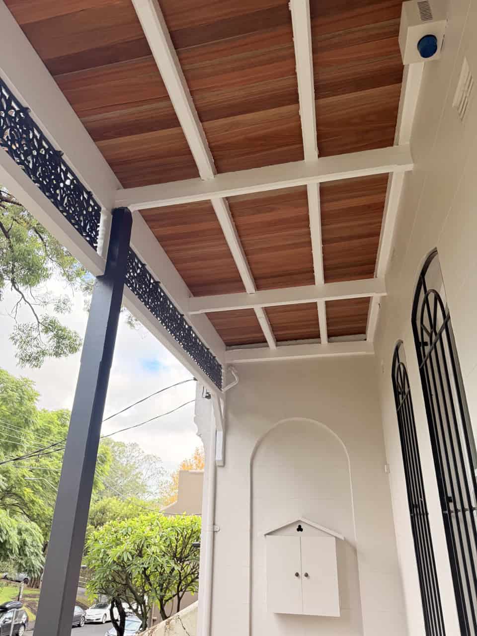 Underside of finished balcony: Restored terrace balcony with hardwood flooring and painted timber framing